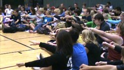 High School stage hypnosis volunteers experience the power of the mind with a light induction technique.